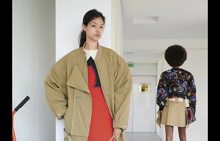 Žena v béžové bundě a červených mini šatech Louis Vuitton