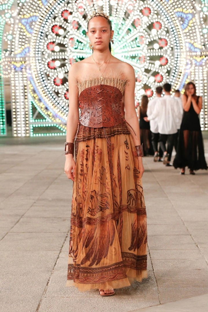 Žena v nude šatech Dior