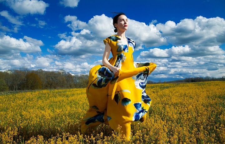 Žena v květovaných šatech na louce